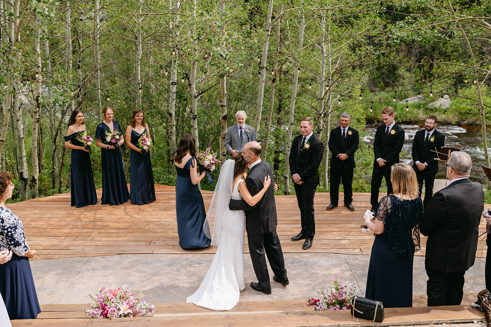 Jason and Amy kissing on the rocks framed by aspen trees